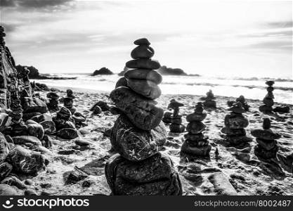 rock balancing at the beach in black and white