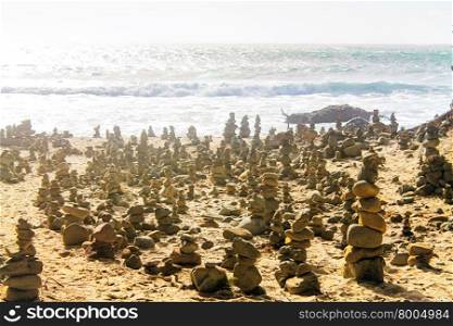 rock balancing at the beach with summer sunlight