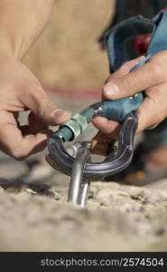 Rock climber concording a carabiner with a hook