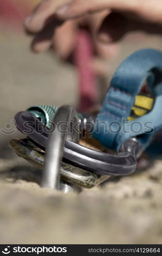 Rock climber concording a carabiner with a hook