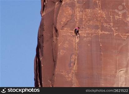 Rock climber on cliff, Utah