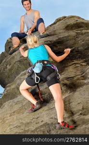 Rock climbing active young woman man holding rope on top