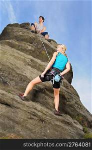 Rock climbing active young woman man holding rope on top