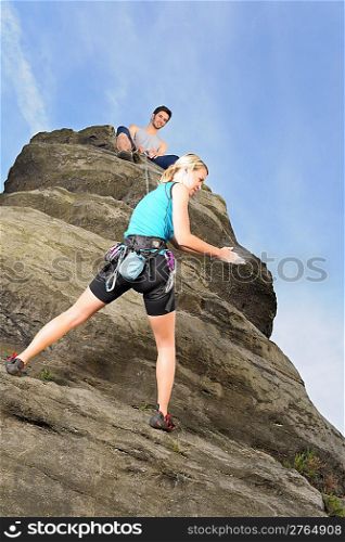 Rock climbing active young woman man holding rope on top