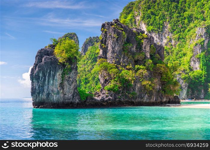 rock covered with trees in the Andaman Sea on the island of Hong, Thailand
