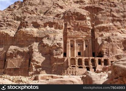 Rock face and royal tomb in mountain Petra, Jordan