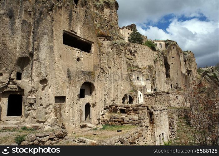Rock face with caves in old town Guzelurt in Cappadocia, Turkey
