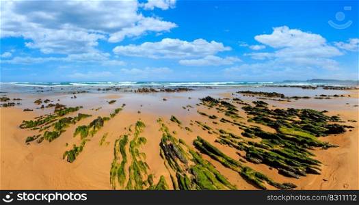 Rock formations on sandy beach  Algarve, Costa Vicentina, Portugal .
