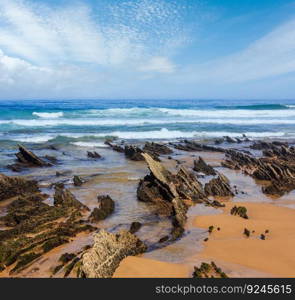 Rock formations on sandy beach (Algarve, Costa Vicentina, Portugal).