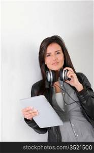 Rock girl listening to music with electronic tablet