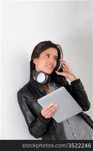Rock girl listening to music with electronic tablet