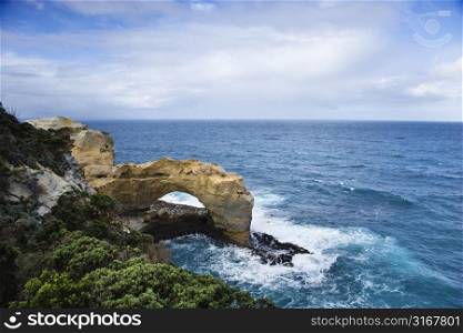 Rock in arch shape on coastline of Australia as seen from Great Ocean Road.