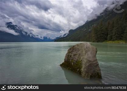 Rock in foreground of serene sky above Chilkoot Lake. Location is Haines, Alaska, United States. Horizontal image with copy space. Excellent salmon fishing in this Southeast Alaska area.