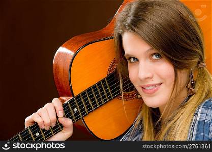 Rock musician - young fashion female model posing with guitar