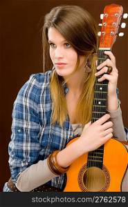 Rock musician - young fashion female model posing with guitar