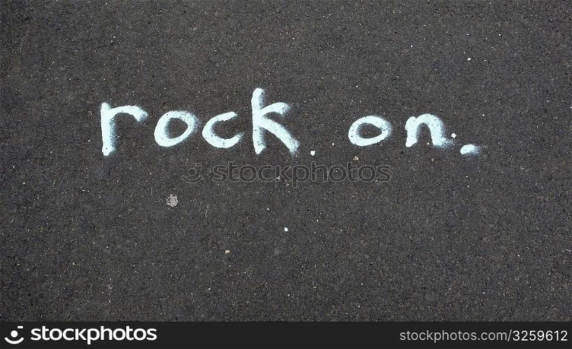 Rock On, written in chalk on sidewalk.
