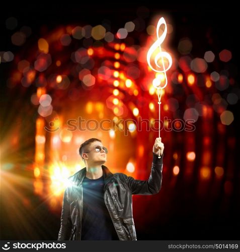 Rock star. Image of young man rock musician in lights