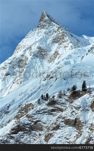 Rock with a pointed top. Winter snowy peaceful Samnaun Alps landscape (Swiss).