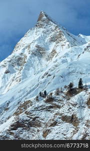 Rock with a pointed top. Winter snowy peaceful Samnaun Alps landscape (Swiss).