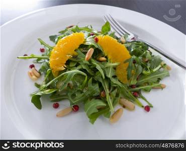 Rocket salad with orange, pepper and pine nuts. Arugula salad with oranges and pine nuts