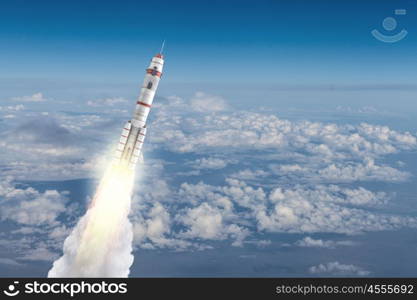 Rocket Space Ship. Military missile flying high in blue sky