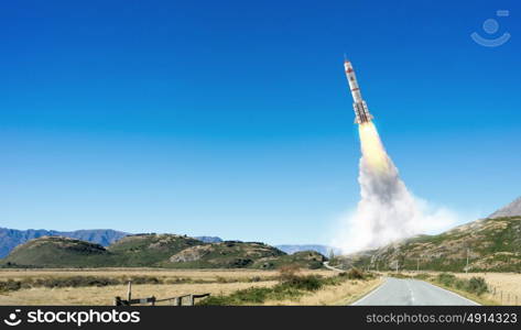 Rocket Space Ship. Military missile flying high in blue sky