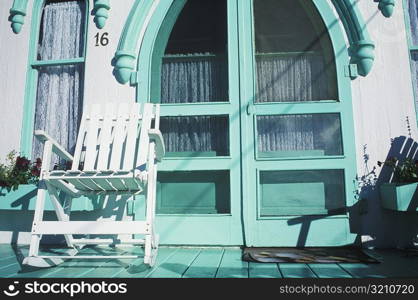 Rocking chair in front of a closed door