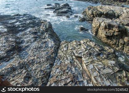 Rocks along the sea shore that has been struck by the waves