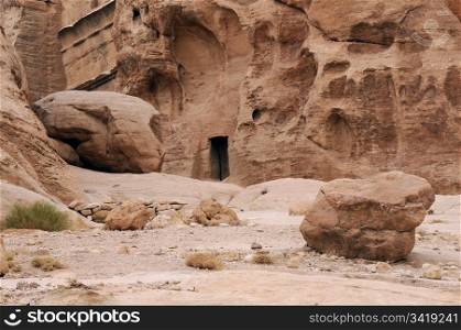 Rocks and ancient tomb in the mountains of Petra in Jordan