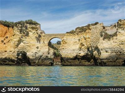 rocks and cliff with stairs and bridge in algarve city lagos in Portugal, the most beautifull coastline of the world