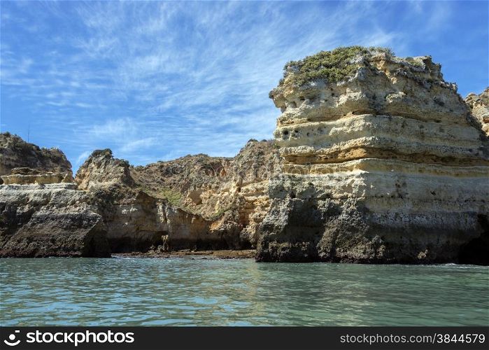 rocks and cliff with stairs and bridge in algarve city lagos in Portugal, the most beautifull coastline of the world seen from a boat