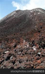 Rocks and conical peak of volcano Krakatau in Indonesia