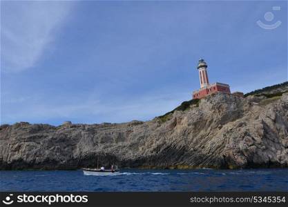Rocks and sea under blue sky. lighthouse on mountain