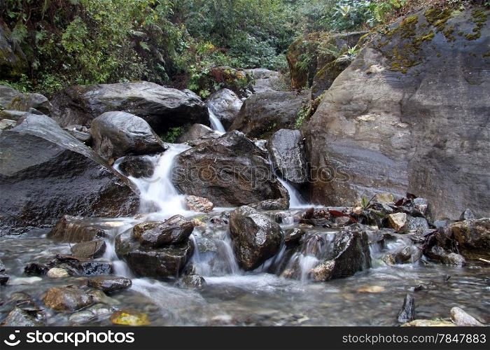 Rocks and small waterfall in mountain in NEpal