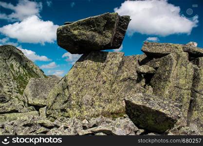 Rocks and stones under blue sky with clouds. Travel to mountains, mountaineering
