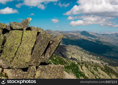 Rocks and stones under blue sky with clouds. Travel to mountains, mountaineering