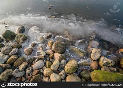Rocks at a frozen lake in the winter