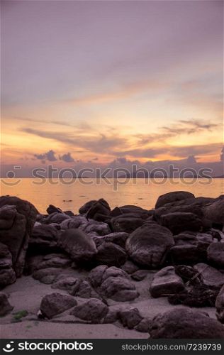 rocks beach sea with sunset in vertical view