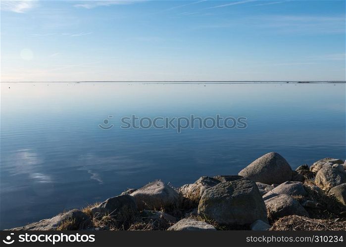 Rocks by a coast with absolutely calm water at the swedish island Oland in the Baltic Sea