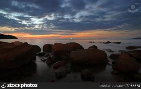 rocks in calm sea at twilight time