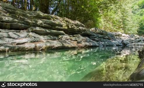 Rocks lake in forest with clear water loop