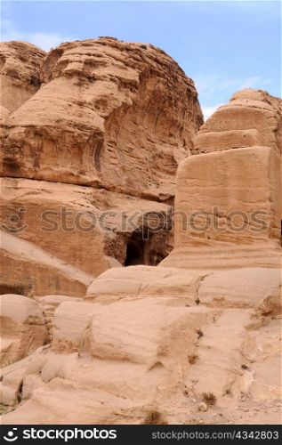 Rocks of Petra in Jordan against the background of blue sky and white clouds