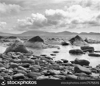 rocks on coast of kerry in west ireland with beara in the background