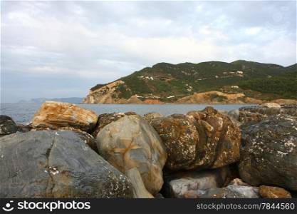 Rocks on defensive bulwark in Skopelos town on Greek island Skopelos