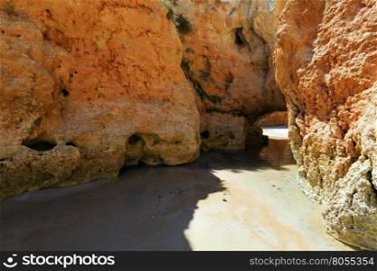 Rocks on sandy beach Dos Tres Irmaos (Portimao, Alvor, Algarve, Portugal).