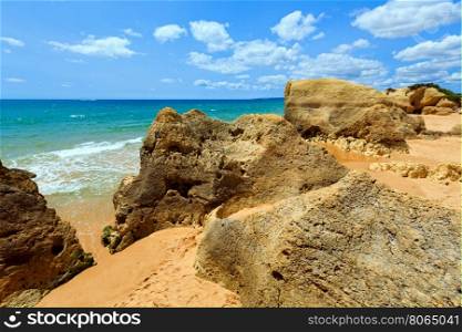 Rocks on summer sandy Albufeira beach (Algarve, Portugal).