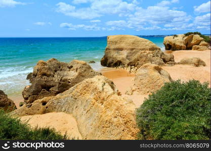 Rocks on summer sandy Albufeira beach (Algarve, Portugal).