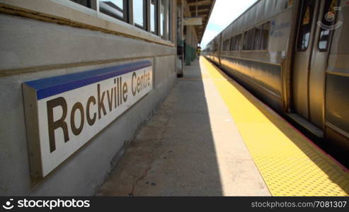 Rockville Centre train passing the station sign