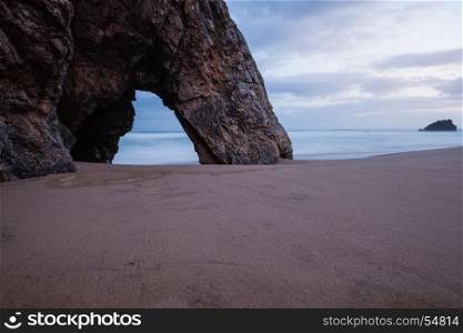 Rocky arch at the Adraga beach, Portugal
