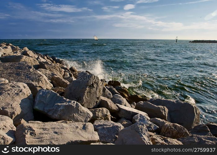 rocky beach with yacht on the horizon. Destin, Florida, USA